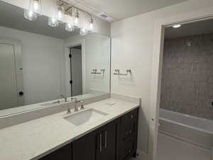 Bathroom with vanity and shower / washtub combination