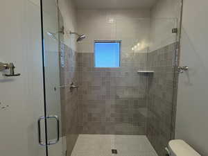 Full bath with a stall shower and toilet