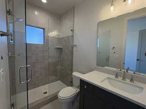 Bathroom featuring vanity and a stall shower