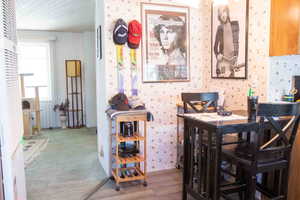 Dining room featuring LVP floors and wallpapered walls