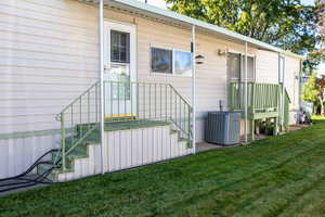 View of side of home with a yard