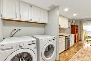 Washroom featuring washer and dryer, recessed lighting, and electric panel
