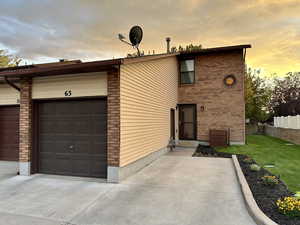 View of front facade with brick siding and a garage
