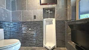 Full bathroom featuring tile walls and tile patterned flooring
