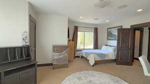 Bedroom featuring light colored carpet and recessed lighting