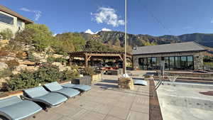 View of patio featuring a pergola, a mountain view, and an outdoor living space with a fire pit