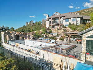 Rear view of house featuring a pergola, a patio, and a chimney