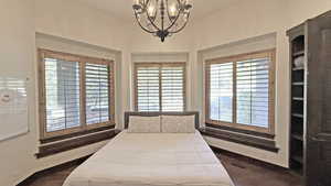 Bedroom with multiple windows and a chandelier