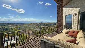 Balcony featuring a mountain view and an outdoor living space