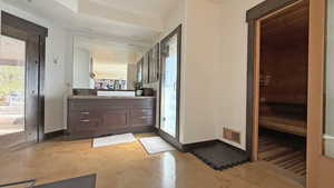 Bathroom with a relaxing sauna, vanity, and finished concrete floors