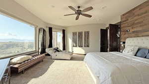 Bedroom with wood walls, carpet floors, ceiling fan, and recessed lighting
