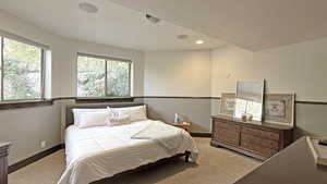 Bedroom with carpet, recessed lighting, and a textured ceiling