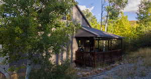 View of home's exterior with a deck and a metal roof