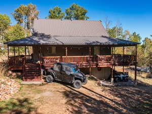 Chalet / cabin with a metal roof and covered porch