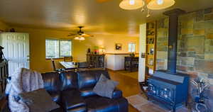 Living room featuring a wood stove and wood finished floors