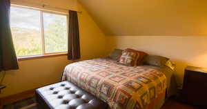 Bedroom with lofted ceiling