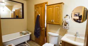 Full bathroom with a soaking tub and vanity