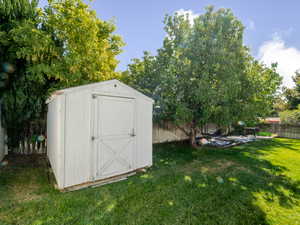 View of shed featuring a fenced backyard