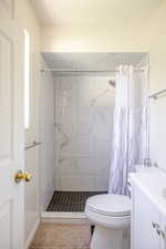 Full bathroom with vanity and a stall shower