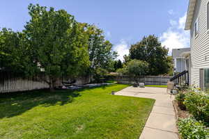 Fenced backyard with a patio area