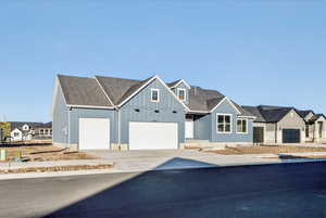 Modern farmhouse style home with concrete driveway and a residential view