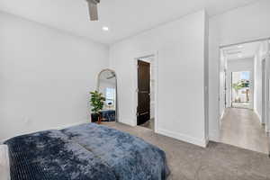 Carpeted bedroom featuring ceiling fan and recessed lighting