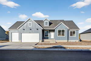 View of front of house featuring a shingled roof, driveway, a garage, and board and batten siding