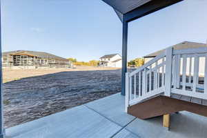 View of patio with a wooden deck