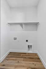 Washroom featuring hookup for a washing machine, hookup for an electric dryer, and wood finished floors