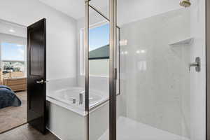 Bathroom featuring a bath, a marble finish shower, ensuite bath, and carpet floors