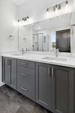 Bathroom with double vanity and a shower stall