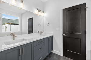 Bathroom featuring double vanity and baseboards