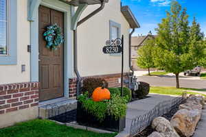 Property entrance featuring brick siding