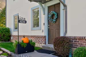 Doorway to property with brick siding