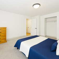 Bedroom with light carpet and baseboards