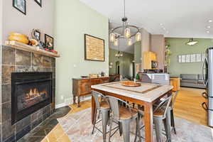 Over sized Eat in Kitchen with Bamboo Flooring, Vaulted Ceilings, Gas Fire Place, and Sliding Glass Doors to the yard.