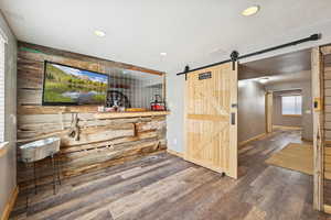 Wet Bar and Lounge with Dining Space, Fridge, LVT Flooring and Barn DoorPublic
