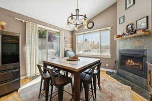 Over sized Eat in Kitchen with Bamboo Flooring, Vaulted Ceilings, Gas Fire Place, and Sliding Glass Doors to the yard.