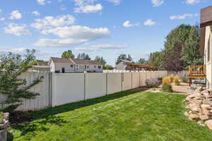 Side Yard with Shed, Water Feature, and Lush Grass, Lot Partially Fenced