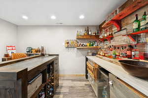 Wet Bar and Lounge with Dining Space, Fridge, LVT Flooring and Barn DoorPublic