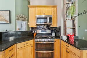 Kitchen with Alder Wood Cabinets, Granite Counters, Stainless Counters, Bamboo Floors
