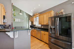Kitchen with Alder Wood Cabinets, Granite Counters, Stainless Counters, Bamboo Floors