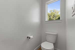 Bathroom featuring toilet and baseboards