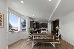 Dining space with recessed lighting and light wood finished floors