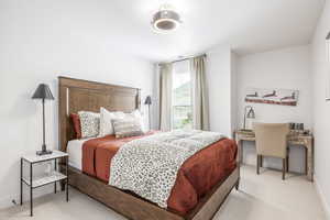 Carpeted bedroom with baseboards