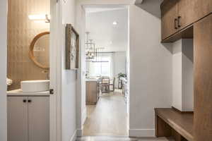 Mudroom with light wood-style flooring and recessed lighting