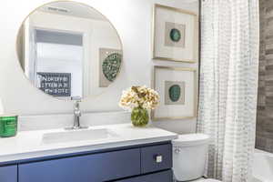Bathroom with vanity and shower / bath combination with curtain