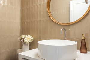 Half bathroom with tile walls