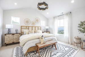 Carpeted bedroom with lofted ceiling and recessed lighting