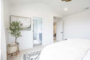 Bedroom with lofted ceiling, connected bathroom, light carpet, and recessed lighting
